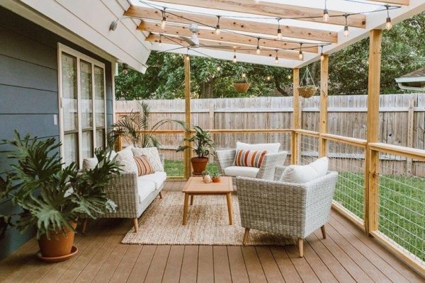 a backyard entertainment area with a roof