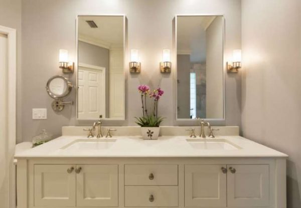 a well-lit bathroom that boasts a double vanity sink