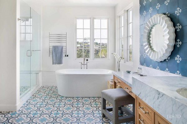 a beautiful bathroom covered in blue accent tiles