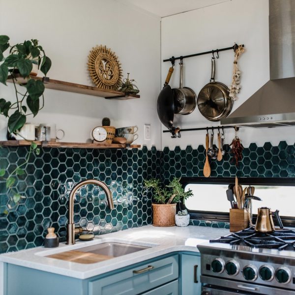a stunning kitchen with green hexagon tiles