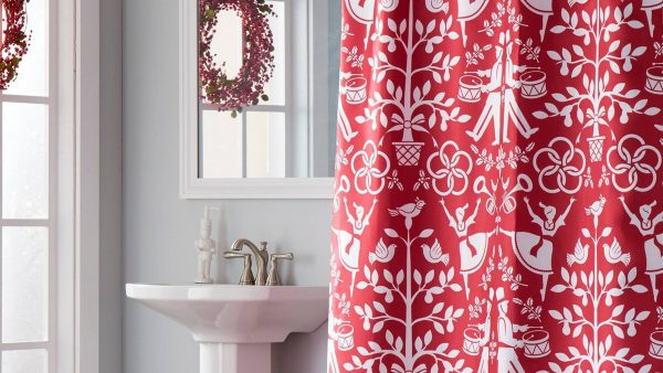 A bathroom decorated with a red festive christmas shower curtain