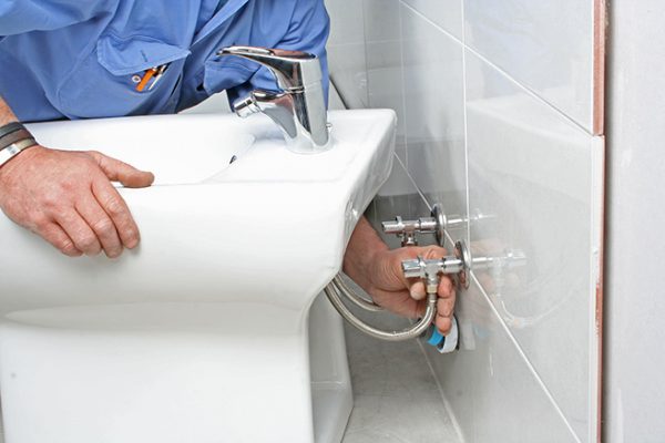construction worker installing a bidet in a bathroom