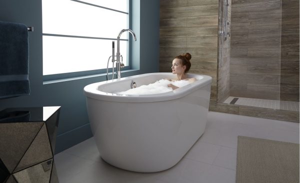 a woman enjoying a relaxing bath in a stand alone tub